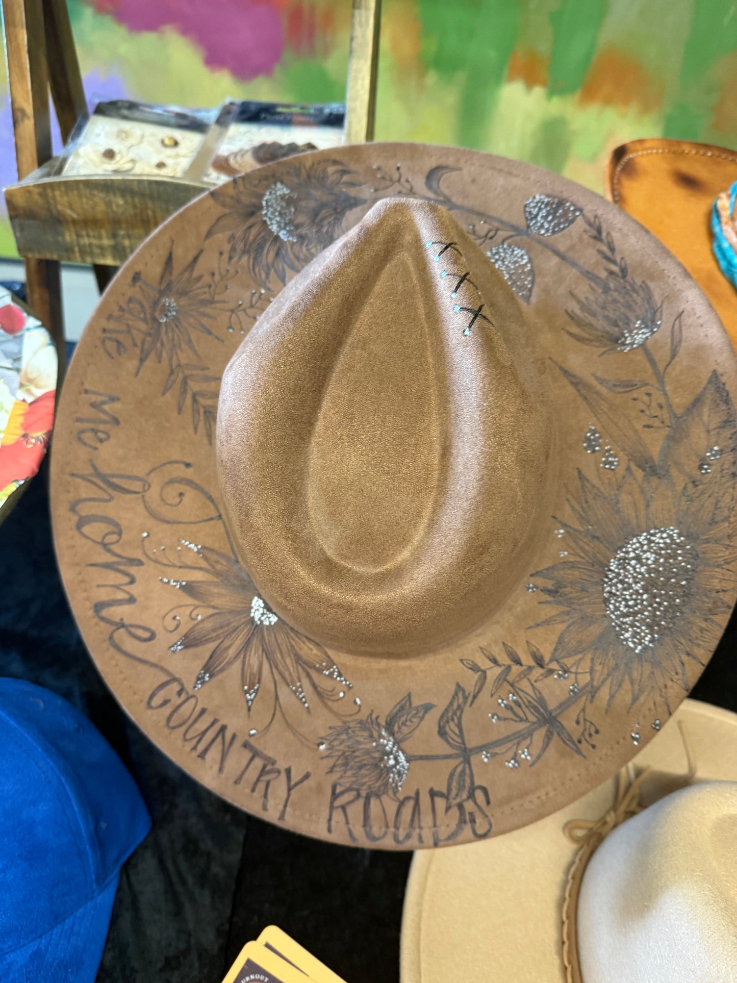 "Oakley" - a gorgeous brown, hand burned hat with flowers.