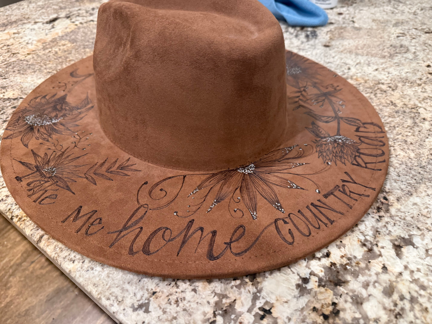 "Oakley" - a gorgeous brown, hand burned hat with flowers.