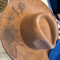 "Oakley" - a gorgeous brown, hand burned hat with flowers.
