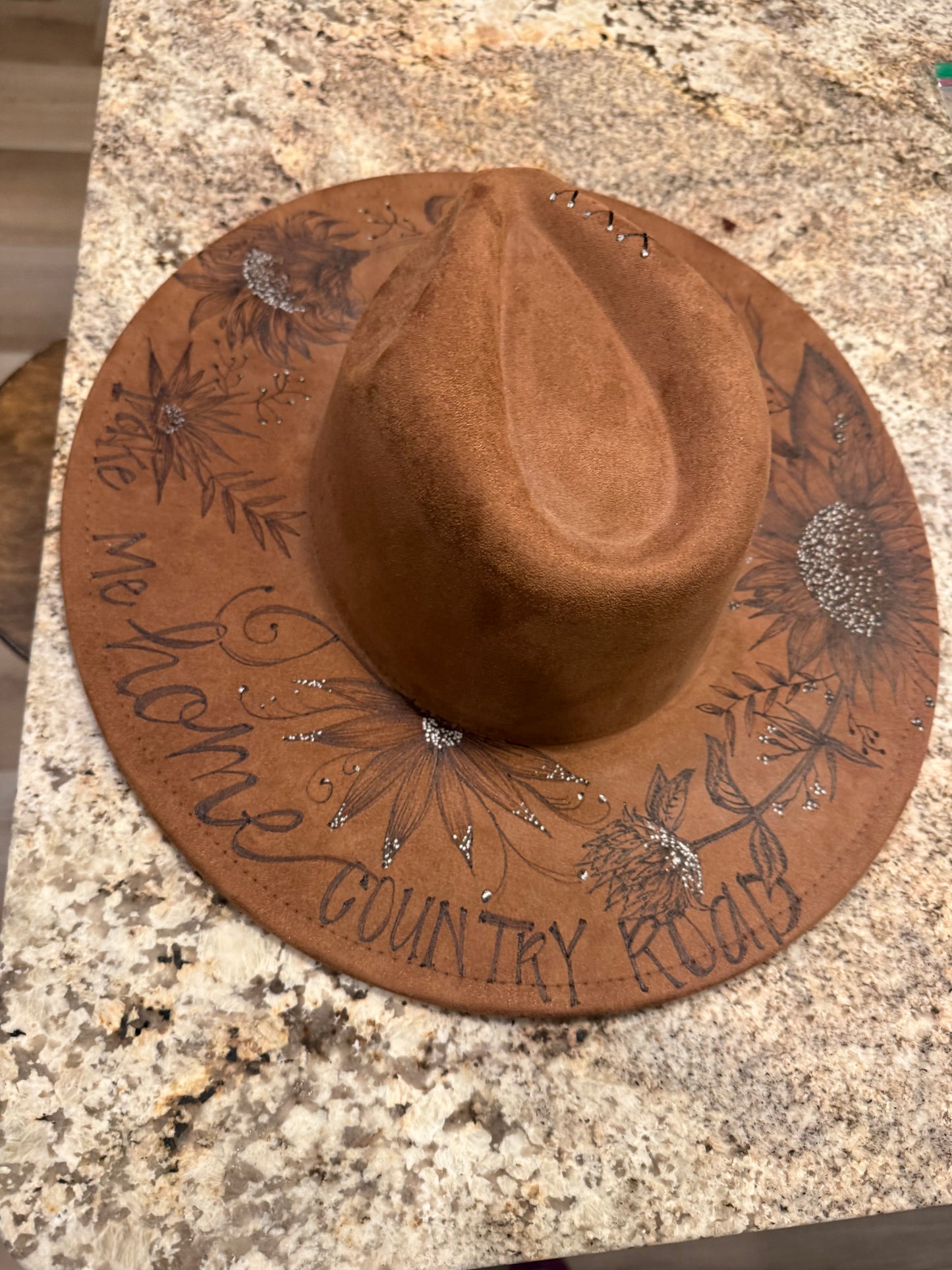 "Oakley" - a gorgeous brown, hand burned hat with flowers.